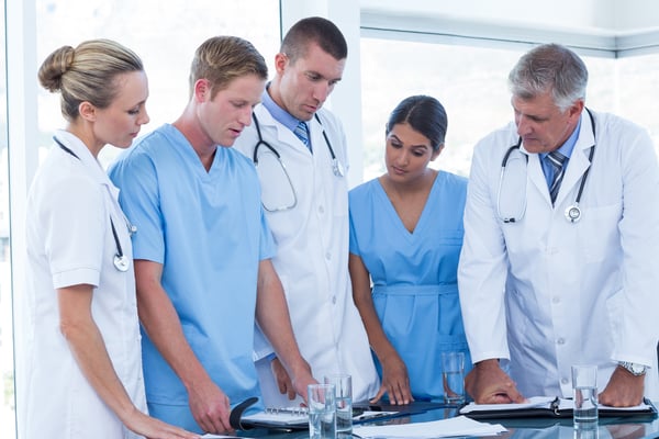 Team of doctors looking at their diaries in the meeting room